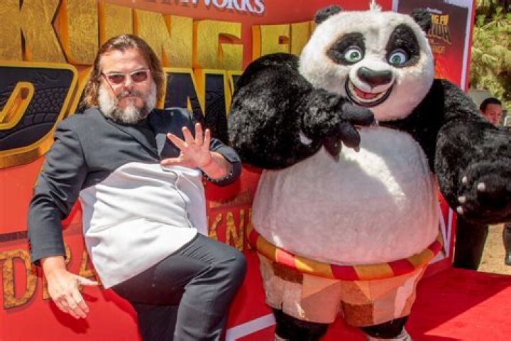Jack Black posing with a Minecraft image behind him.